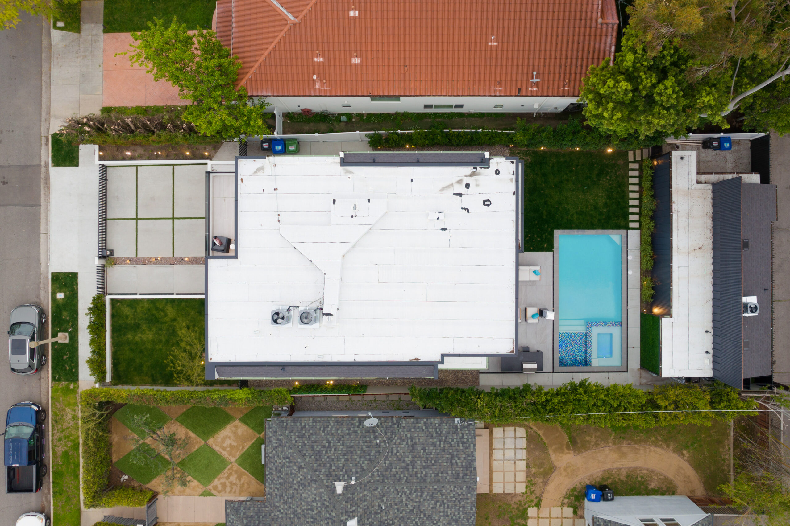 Aerial view of a house and pool in a residential area