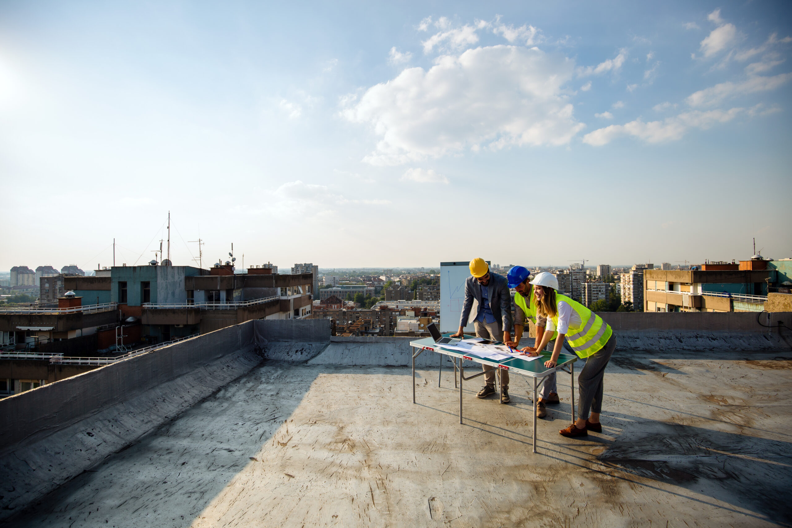 Team of architects and engineers people in group on construciton site check documents